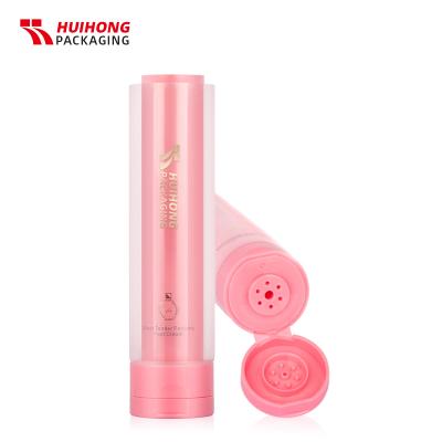 tubo de doble cámara exprimible de crema de manos mate de caña de azúcar rosa con tapa abatible
